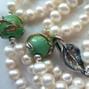Spring Garden.
Double row of snow white 6mm. - 8mm. freshwater pearls with hand made spring green lampwork glass beads and sterling silver accent beads and clasp.