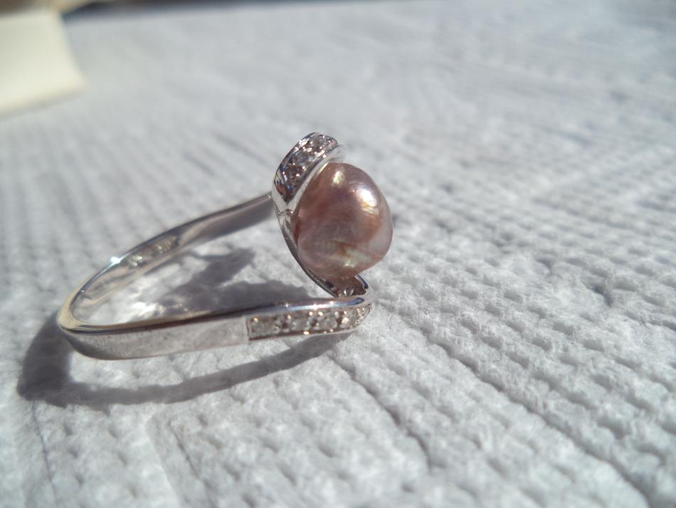 Wild caught, natural pearl set into ring side view