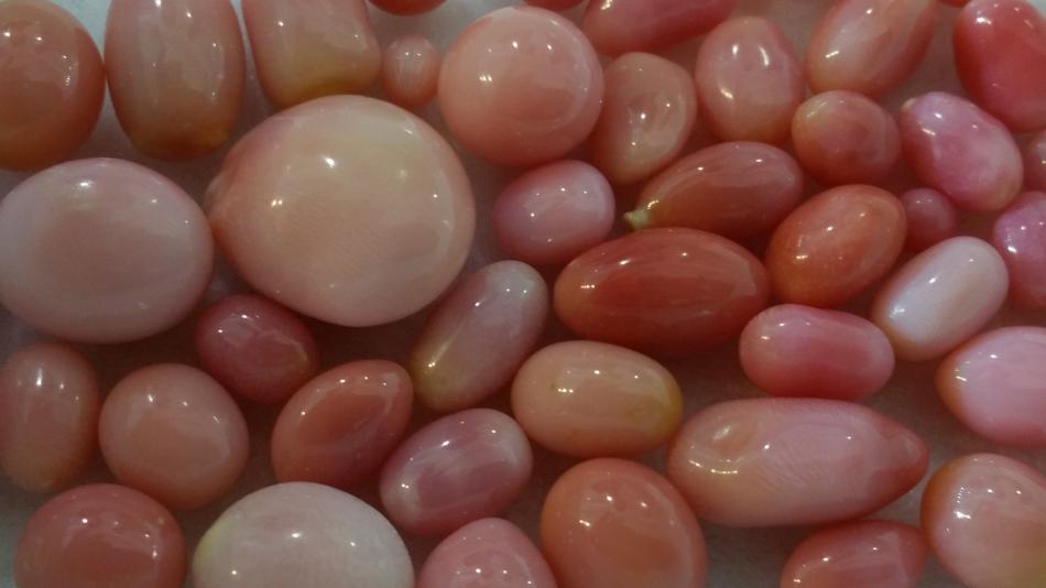 A mix of pink conch pearls
