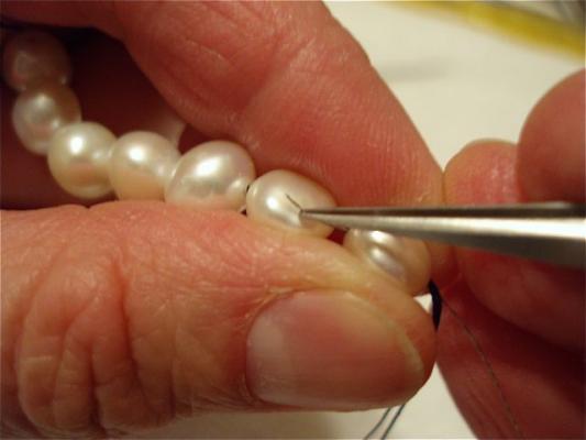Beaders Secret using tweezers to pull the needle out from between the pearls.jpg