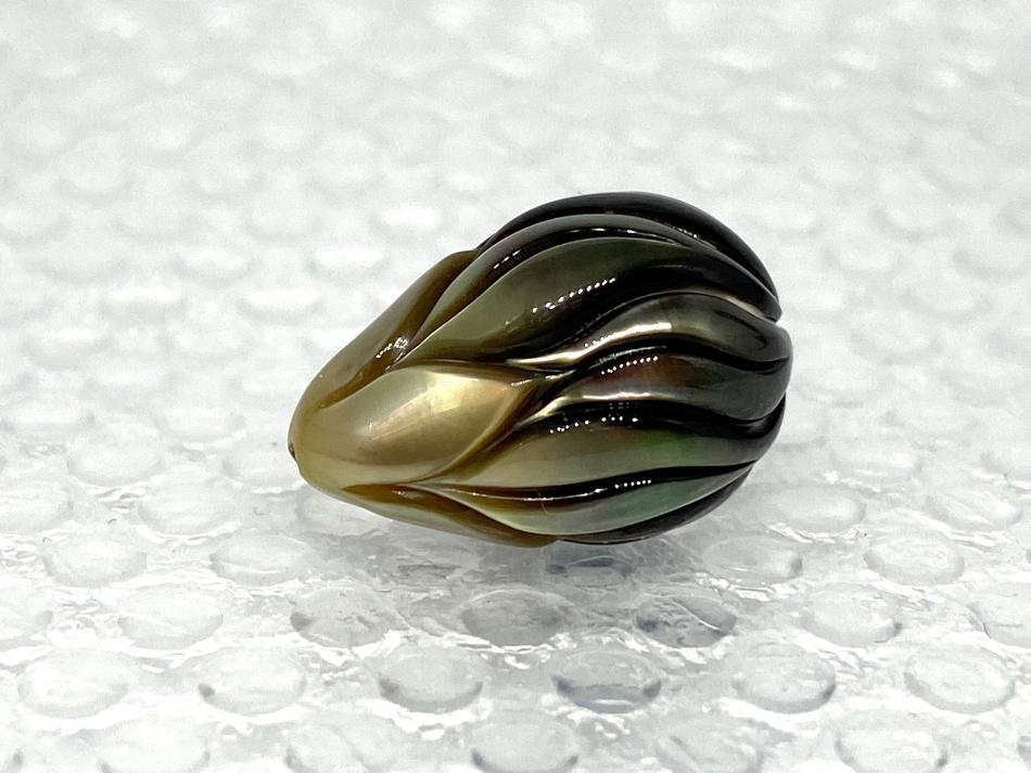 A single carved, drop-shape,12.7 x 18.4 mm Tahitian pearl