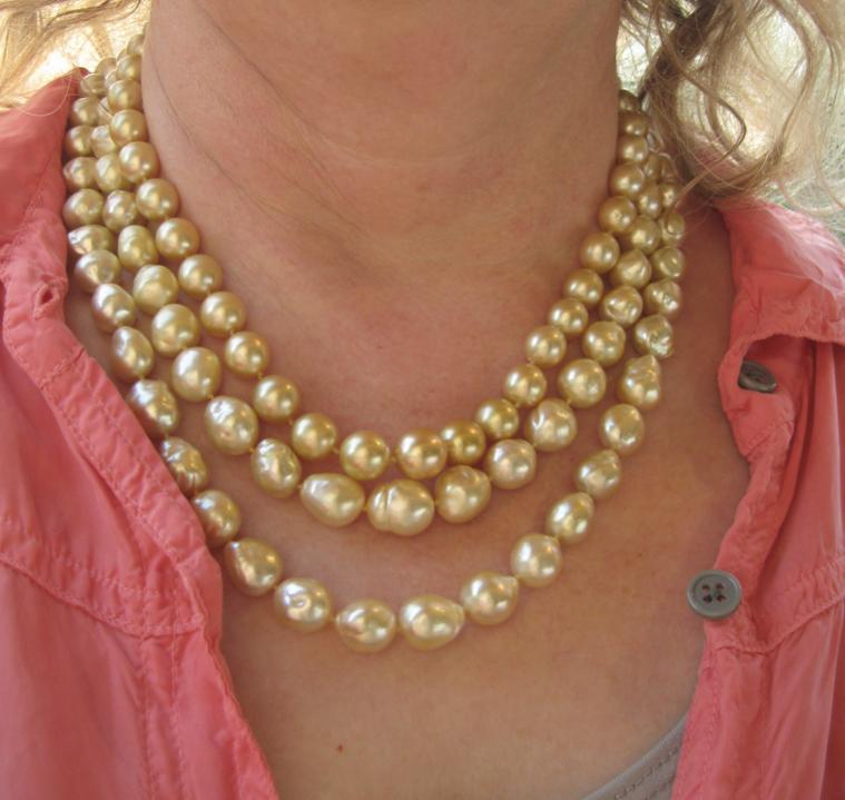 three strands of golden pearls close up