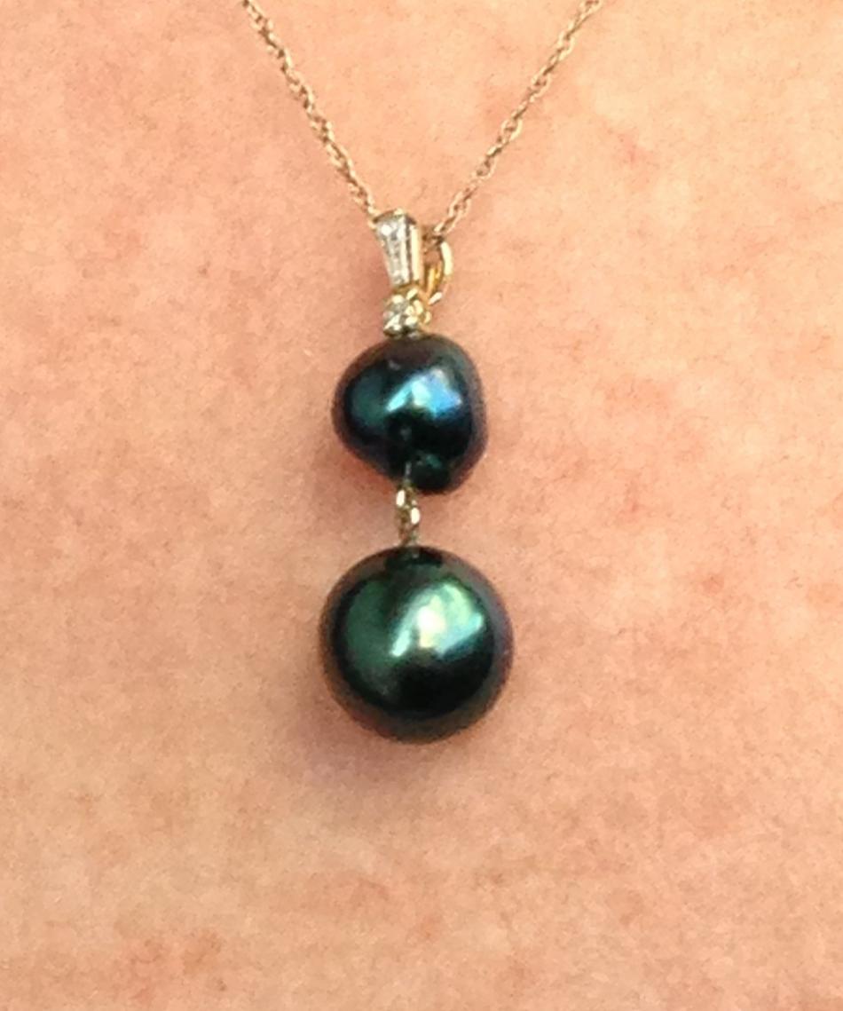 Pearl Paradise provoked Baroque blue Tahitian pearl with a green Robert Wan Tahitian pearl