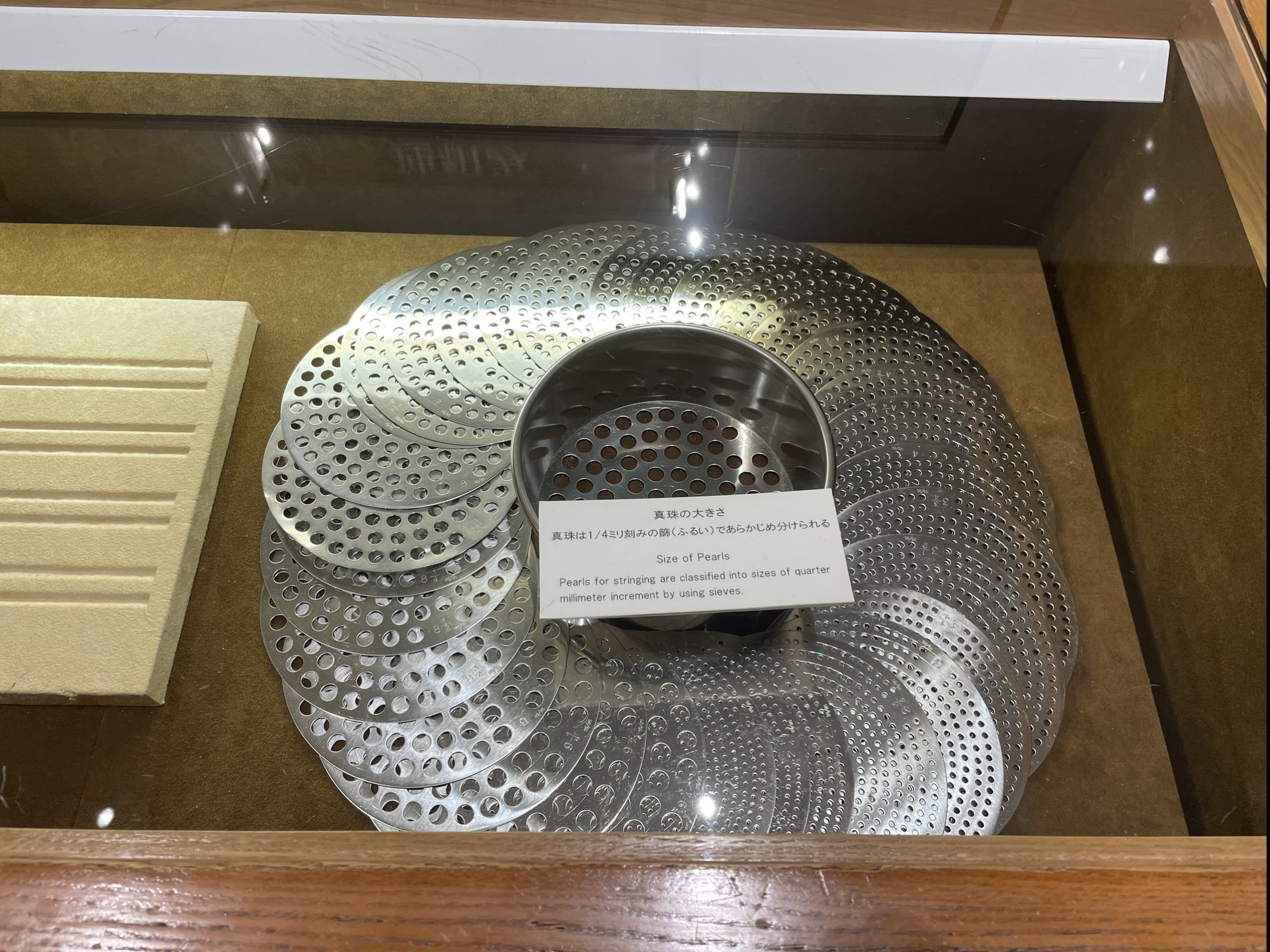 Device used to sort pearls by size - Mikimoto Pearl Museum