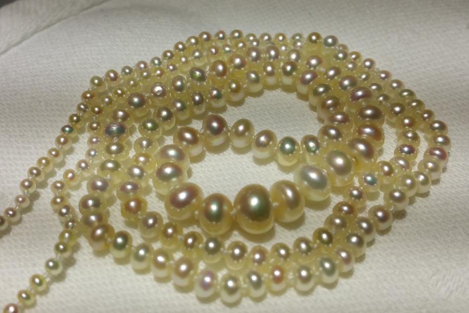 KC Bell: Long graduated strand of natural pearls