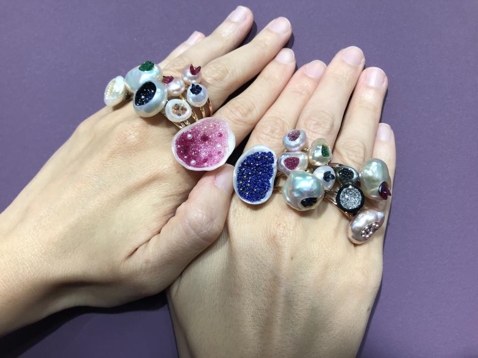 fingers adorned with little h pearl geode rings