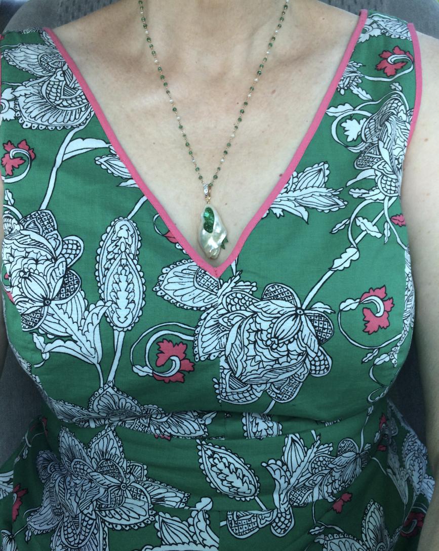 little h souffle' and emerald pendant with a tin cup