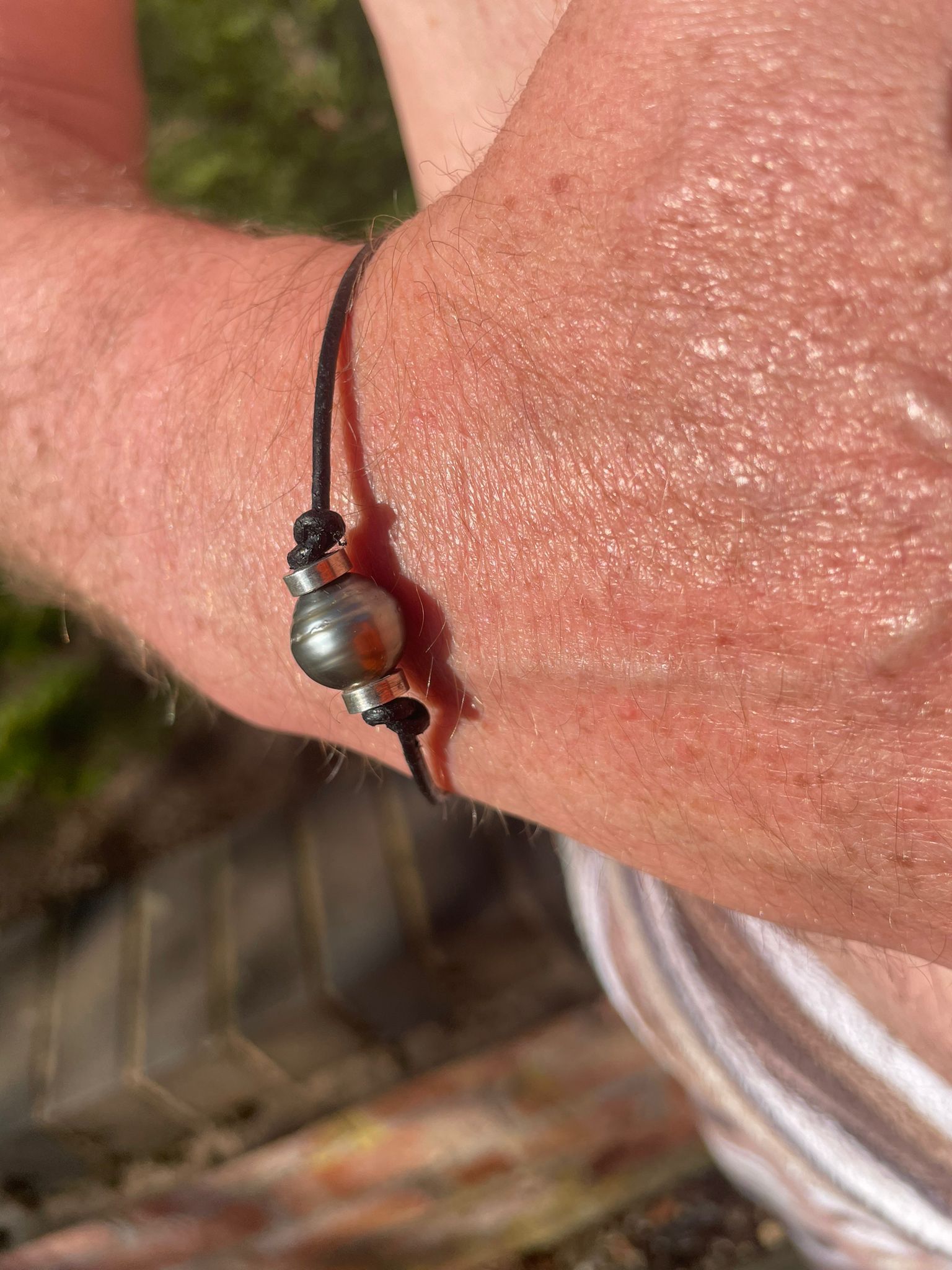 A matching single Tahitian pearl on leather bracelet