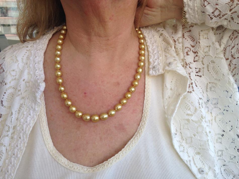 Trying on the gold South Sea strand