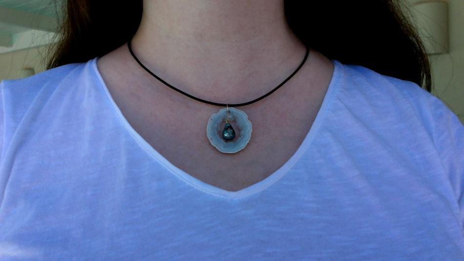 little h: a pearl geode inside a geode slice