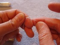 Stringing tutorial 6- forming an overhand knot.jpg