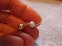 Stringing tutorial 11- Hold clasp and end pearl in left hand.jpg