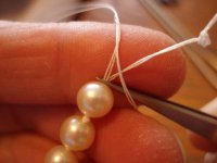 Stringing tutorial 18b-- Holding the tweezers to make a knot ofter the 3rd pearl.jpg