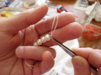As usual, insert the tweezers through the loop to grasp the threads just above the pearl.jpg