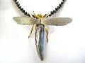 dragonfly with one large free form natural abalone pearl. The wings are made of 18ct yellow gold.