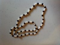 All pearls are fresh waters of various shapes. Red and gold ones are dyed. Peach and mauve ones are natural color I think, no visible evidence of dyeing at the holes or in ant of the pits and other imperfections on the pearls where dye tends to collect. Amethyst, garnet, and black onyx beads were also used