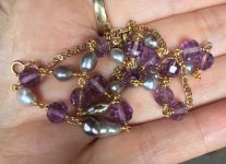 fancy cut amethyst and Sea of Cortez keshi necklace in hand