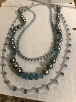 Restringing pearls with aquamarine and white topaz stones