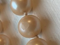 I received Pearls handed down in the family but am not sure they are real. One is chipped and they appear to lack luster. I included a photo to assist