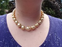 my daughter wearing her golden SS pearls.jpeg