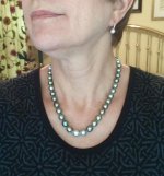 wearing a strand of Pearl Paradise Tahitian pearls with Mikimoto huggie earrings