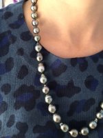 Close up wearing Tahitians pearls with blue shirt.JPG