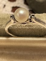 The Pearl on my silver 950 ring glows with blue circle under artificial light