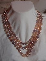 Triple strand undyed freshwater cultured pearls on silk with sterling silver.jpg