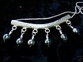 6 peacock tahitian pearls hanging from a heavy hammered Hill Tribe Silver bar pendant.  Probably my 
