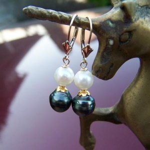 Evergreen Tahitian pearl earrings with akoya pearl on top.  Set on fleur de lis 14k leverbacks with 14k bali gold daisy caps between.