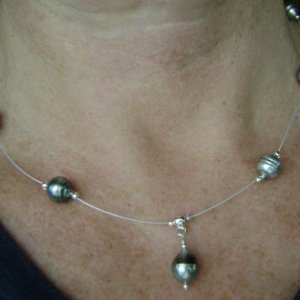 Kamoka silver circle'  on beading wire.