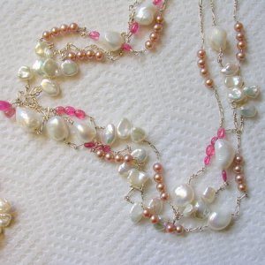 very long silver necklace with small pink pearls, keshi petals, white baroques and pink sapphires and spinels