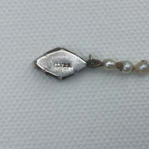 Lettering on clasp looks like an old stamp